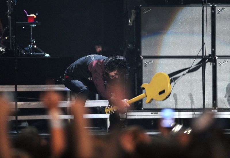 LAS VEGAS, NV - SEPTEMBER 21:  Frontman Billie Joe Armstrong of Green Day smashes his guitar as he performs onstage during the 2012 iHeartRadio Music Festival at the MGM Grand Garden Arena on September 21, 2012 in Las Vegas, Nevada.  (Photo by Isaac Brekken/Getty Images for Clear Channel)