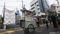 Bahkan terlihat PKL tetap berjualan di depan spanduk penolakan warga.