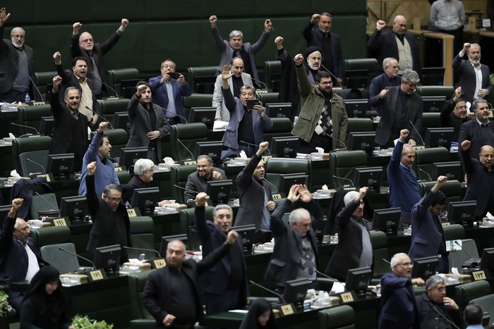 Iranian lawmakers chant slogans in a debate on an urgent bill declaring the U.S. militarys command at the Pentagon in Washington and those acting on its behalf terrorists, subject to Iranian sanctions, in an open session of parliament, in Tehran, 