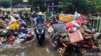 Seorang warga melintas di jalan Darma Wanita, Rawa Buaya, Cengkareng, Jakarta Barat, Selasa (7/1/2020).