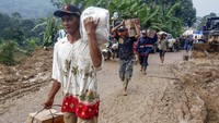 Sejumlah relawan mendistribukan bantuan sembako dan pakaian untuk korban longsor di Desa Harkat Jaya, Sukajaya, Bogor, Jawa Barat, Rabu (8/1/2020). 