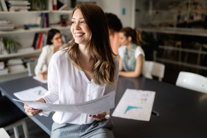 zodiak Group of young business people are working together in modern office. Creative people with laptop, tablet, smart phone, notebook. Successful hipster team in coworking. Freelancers.