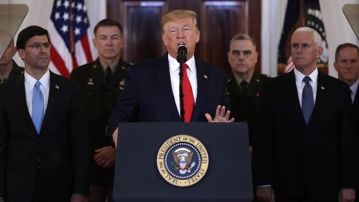 President Donald Trump addresses the nation from the White House on the ballistic missile strike that Iran launched against Iraqi air bases housing U.S. troops, Wednesday, Jan. 8, 2020, in Washington, as Secretary of Defense Mark Esper, Chairman of the Joint Chiefs of Staff Gen. Mark Milley, and Vice President Mike Pence, and others look on. (AP Photo/ Evan Vucci)