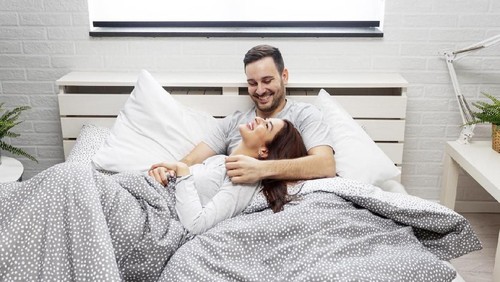 Young couple  lying in the bed early in the morning in bedroom