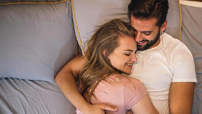 Young couple  lying in the bed early in the morning in bedroom
