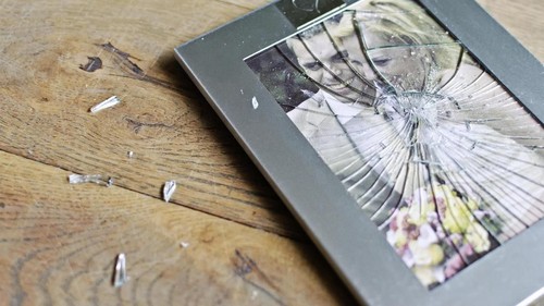 Unhappy young millennial married couple sitting on couch in living room after quarrel fight. Angry husband frustrated offended wife at home. Break up, divorce and misunderstanding in relations concept