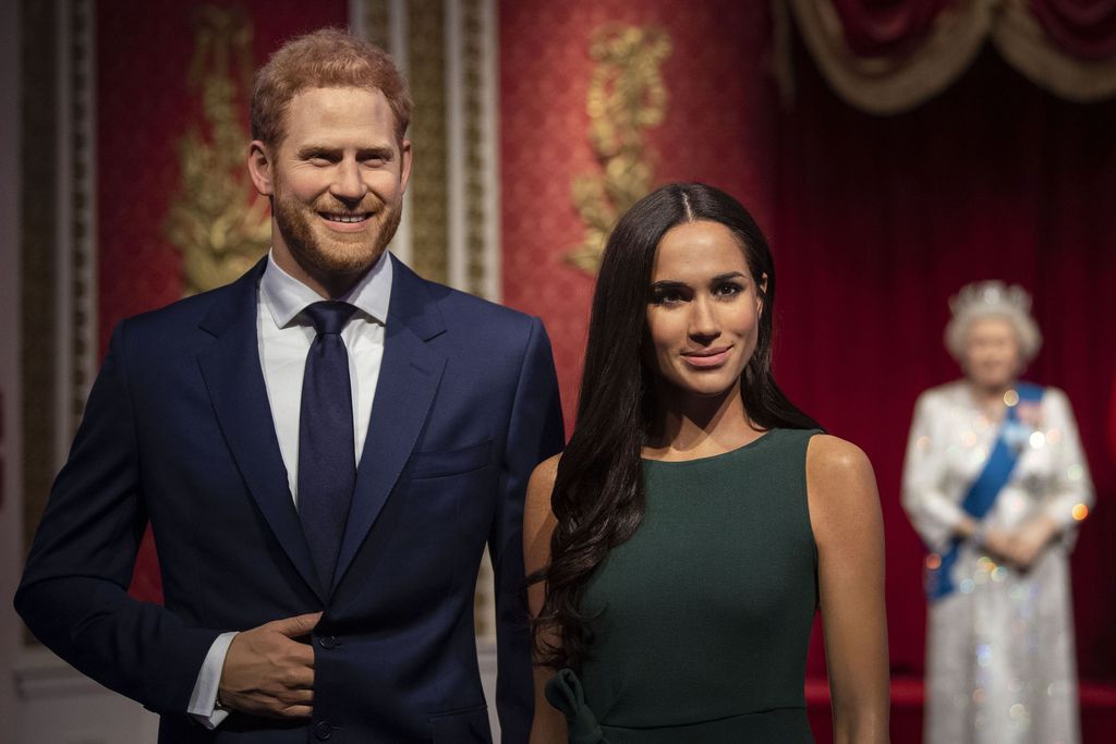The figures of Britain's Prince Harry and Meghan, Duchess of Sussex, left, in their original positions next to Queen Elizabeth II, Prince Philip and Prince William and Kate, Duchess of Cambridge, at Madame Tussauds in London, Thursday Jan. 9, 2020. Madame Tussauds moved its figures of Prince Harry and Meghan, Duchess of Sussex from its Royal Family set to elsewhere in the attraction. (Victoria Jones/PA via AP)