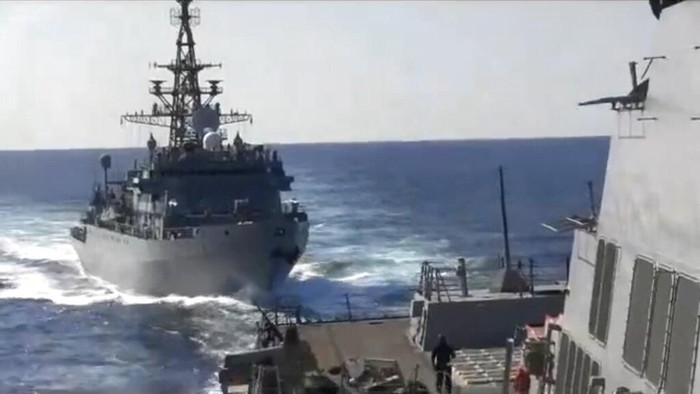 This photo provided bythe U.S. 5th Fleet, shows a Russian Navy ship approaching an American warship in the North Arabian Sea, on Thursday, Jan. 9, 2020.  A spokesman for U.S. 5th Fleet said Friday that the USS Farragut was conducting routine operations Thursday and sounded five short blasts to warn the Russian ship of a possible collision. He said the USS Farragut asked the Russian ship to change course and the ship initially refused but ultimately moved away. Even though the Russian ship moved away, the Navy spokesman said the delay in shifting course increased the risk of collision   (U.S. 5th Fleet via AP)
