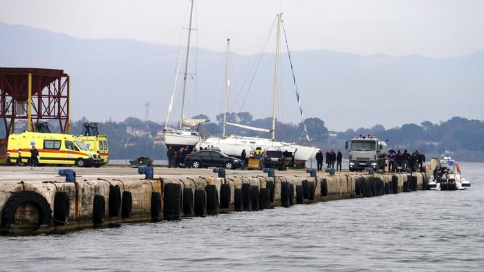 Greek authorities at the scene, on the port of Preveza, northwestern Greece, Saturday, Jan. 11, 2020. Greeces coast guard says 12 migrants have been found dead in the Ionian Sea and 21 others have been rescued after their boat took in water and sank. Searchers are looking for more survivors. (Andriana Soldatou/mypreveza.gr via AP)