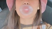 Sambil mengunyah permen karet, Dara Arafah mencoba membuat balon dari permen karet yang dikunyahnya tersebut. Ia pun berhasil mengabadikan ketika balon tersebut bisa dibuat. Foto: Instagram @daraarafah