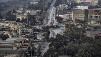 Abu vulkanik dari letusan gunung menutupi jalan dan atap rumah warga. Ezra Acayan/Getty Images.