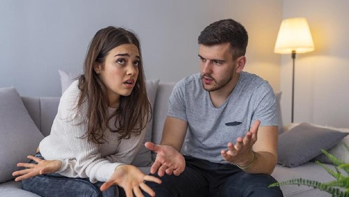 Couples are angry with love issues. Not understanding each other in family problems or infidelity . Couple having argument on the couch at home in the living room