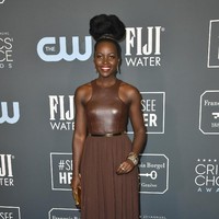 Lupita Nyongo bak ratu Afrika yang edgy dengan gaun kulit beraksen emas dari Michael Kors ini. (Foto: Frazer Harrison/Getty Images)