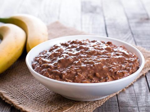 Chocolate oatmeal in white bowl for breakfast, horizontal