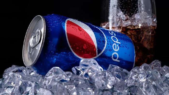 West Palm Beach, USA - March 29, 2011: Variety of brand name soda cans placed in a box in a double row. Brands include Coca Cola, Pepsi, Dr Pepper, Orange Crush, Sprite and Mountain Dew.