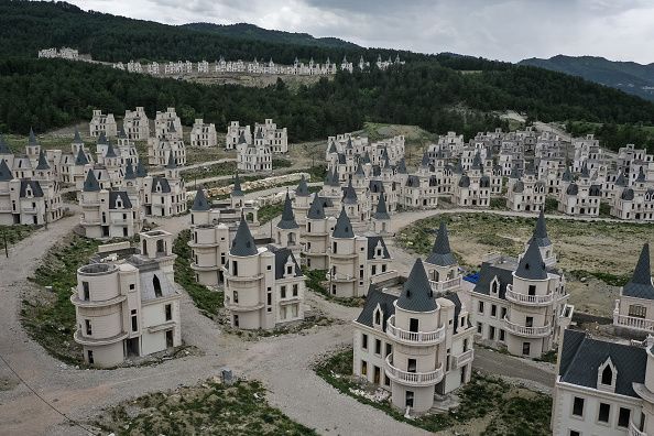 MUDURNU, TURKEY - MAY 21: Hundreds of castle-like villas and houses are seen unfinished at the Burj Al Babas housing development on May 21, 2019 in Mudurnu, Turkey. Construction on the luxury housing project began in 2014 and aimed to build 732 villas, a shopping mall and entertainment facilities targeted at foreign buyers. However the future of the villas is now uncertain after the developers, Sarot Property Group filed for bankruptcy after buyers and investors pulled out of the 150million euro project. The economic downturn and weakening Turkish lira have left many companies unable to pay large foreign currency debts borrowed to finance projects, resulting in many companies filing for bankruptcy and leaving projects unfinished. (Photo by Chris McGrath/Getty Images)