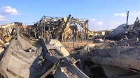 Puing-puing bangunan pangkalan udara Ain al-Asad yang porak poranda masih terlihat di kawasan tersebut. AP Photo/Qassim Abdul-Zahra.