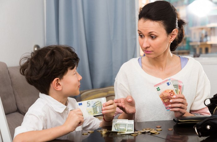 Confident couple trying to manage domestic finances, calculating and making notes