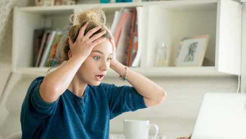 business woman feel depress and use smart phone while drinking coffee in the office