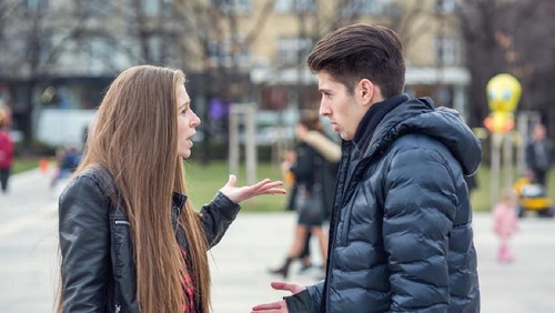 Unhappy housewife sitting near the window