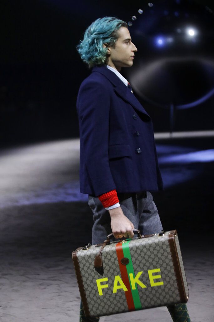 A model wears a creation as part of the Gucci men's Fall-Winter 2020/21 collection, that was presented in Milan, Italy, Tuesday, Jan. 14, 2020. (AP Photo/Luca Bruno)