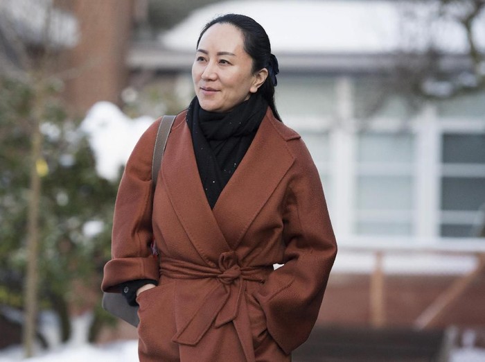 FILE - In this  Jan. 17, 2020, file photo, Huawei chief financial officer Meng Wanzhou, who is out on bail and remains under partial house arrest after she was detained last year at the behest of American authorities, leaves her home in Vancouver, British Columbia, as she heads to B.C. Supreme Court for a case management hearing. The first stage of her extradition hearing begins Monday, Jan. 20, 2020, in a Vancouver courtroom, a case that has infuriated Beijing, set off a diplomatic furor and raised fears of a brewing tech war between China and the United States. (Jonathan Hayward/The Canadian Press via AP, File)