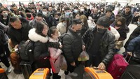 Potret sejumlah warga mengenakan masker saat memenuhi Stasiun Kereta Nantong di Provinsi Jiangsu, China, untuk mudik menjelang Tahun Baru Imlek. Chinatopix via AP.