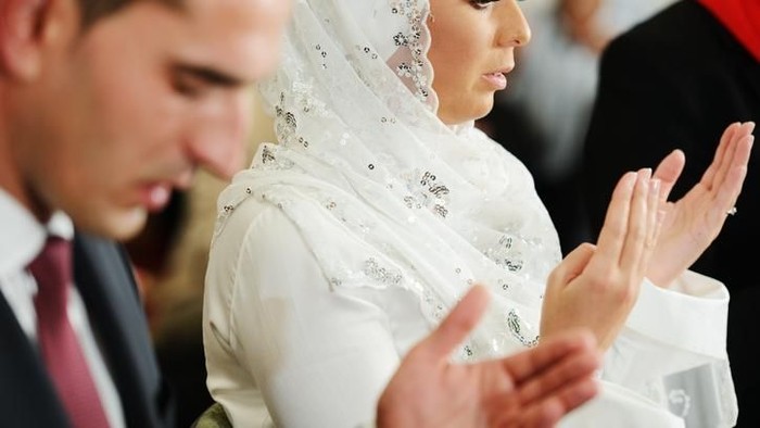 Muslim bride and groom at the mosque during a wedding ceremony