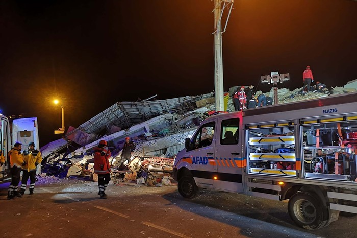 Rescue workers on a collapsed building after a strong earthquake struck Sivrice town in Elazig province, eastern Turkey, Friday, Jan. 24, 2020. The earthquake rocked a sparsely-populated part of eastern Turkey on Friday, injuring more than 500 and leaving some 30 trapped in the wreckage of toppled buildings, Turkish officials said.(DHA via AP)