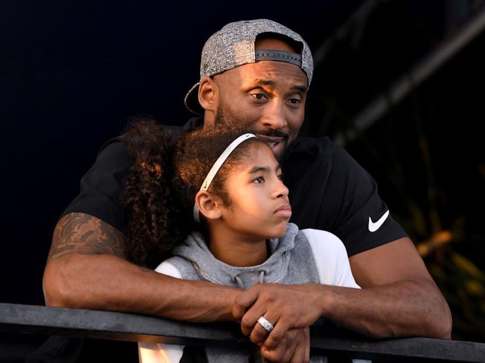 IRVINE, CA - JULY 26:  Kobe Bryant and daughter Gianna Bryant watch during day 2 of the Phillips 66 National Swimming Championships at the Woollett Aquatics Center on July 26, 2018 in Irvine, California.  (Photo by Harry How/Getty Images)