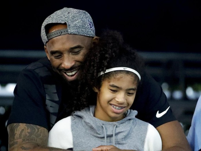 In this June 14, 2009, photo, Los Angles Lakers guard Kobe Bryant celebrates with his daughter Gianna, following the Lakers 99-86 defeat of the Orlando Magic in Game 5 of the NBA Finals at Amway Arena in Orlando. (Stephen M. Dowell/Orlando Sentinel via AP)