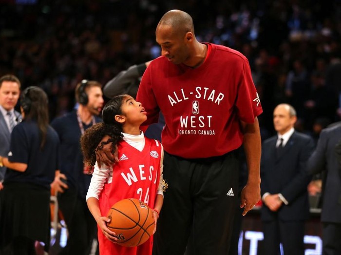 SAN DIEGO, CA - APRIL 10: NBA Los Angeles Laker Kobe Bryant stands on the sideline with his daughter Gianna Maria-Onore Bryant on his shoulders prior to the start of the game against the United States and China during an international firendly match at Qualcomm Stadium on April 10, 2014 in San Diego, California.   Kent C. Horner/Getty Images/AFP