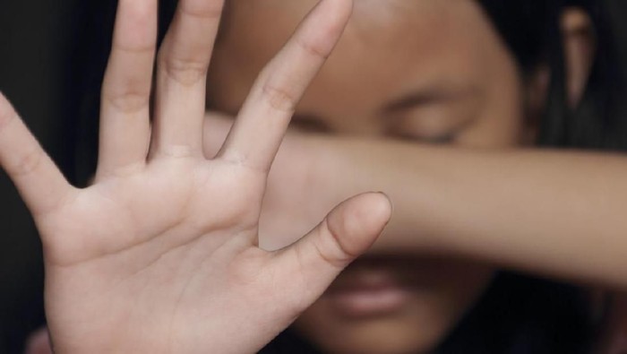Little girl suffering bullying raises her palm asking to stop the violence