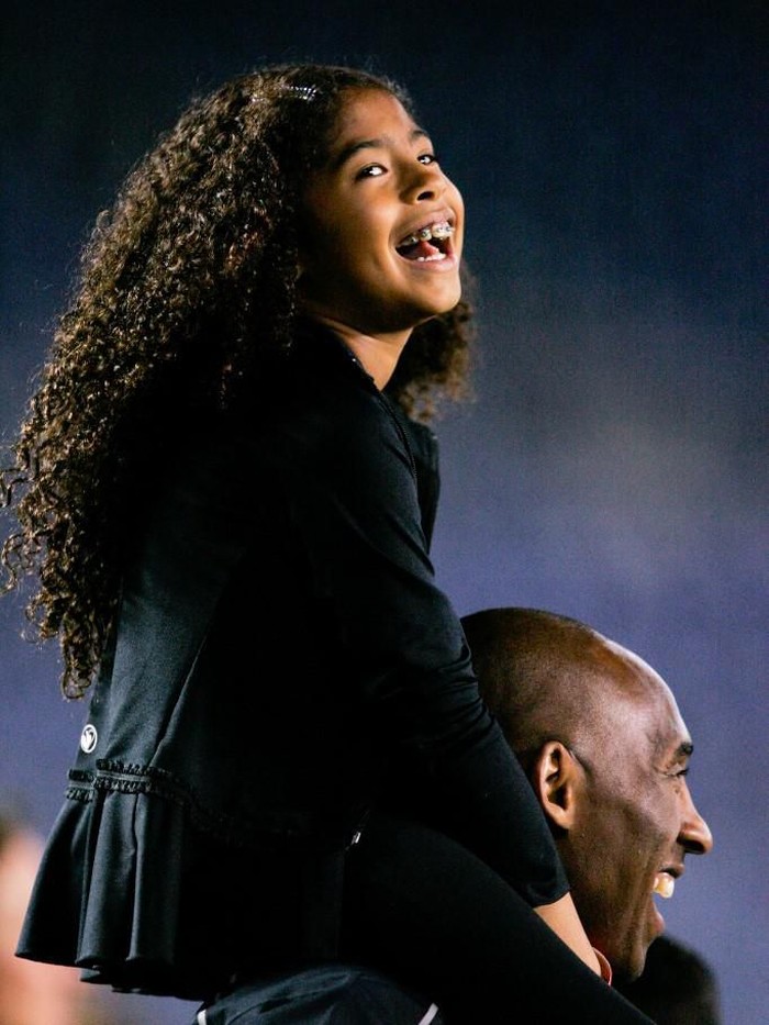 SAN DIEGO, CA - APRIL 10: NBA Los Angeles Laker Kobe Bryant stands on the sideline with his daughter Gianna Maria-Onore Bryant on his shoulders prior to the start of the game against the United States and China during an international firendly match at Qualcomm Stadium on April 10, 2014 in San Diego, California.   Kent C. Horner/Getty Images/AFP