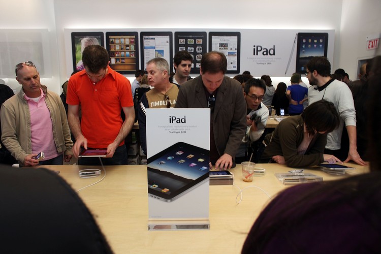 NEW YORK - APRIL 03:  People at the SoHo New York Apple store try out Apple Incs new iPad on April 3, 2010 in New York City. Hundreds lined up in front of the technology companys flagship New York store on the Avenue to be among the first in the world to acquire the device. The much heralded iPad looks to be a bridge between a laptop and smartphone.  (Photo by Spencer Platt/Getty Images)