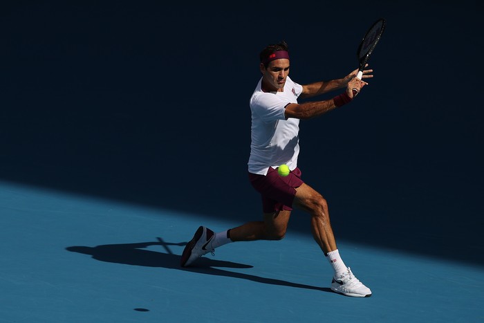 MELBOURNE, AUSTRALIA - JANUARY 28: Roger Federer of Switzerland plays a backhand during his Menâ€™s Singles Quarterfinal match against Tennys Sandgren of the United States on day nine of the 2020 Australian Open at Melbourne Park on January 28, 2020 in Melbourne, Australia. (Photo by Clive Brunskill/Getty Images)