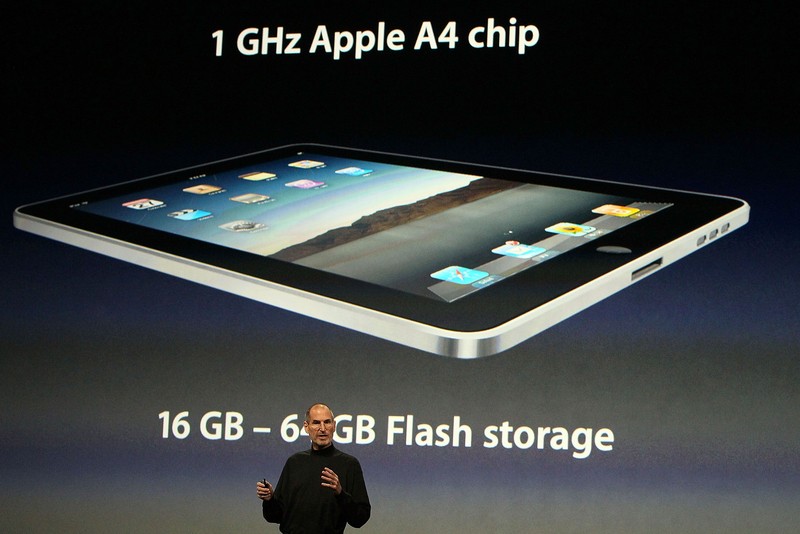 SAN FRANCISCO - JANUARY 27: Apple Inc. CEO Steve Jobs holds up the new iPad as he speaks during an Apple Special Event at Yerba Buena Center for the Arts January 27, 2010 in San Francisco, California. Apple introduced its latest creation, the iPad, a mobile tablet browsing device that is a cross between the iPhone and a MacBook laptop. (Photo by Justin Sullivan/Getty Images)