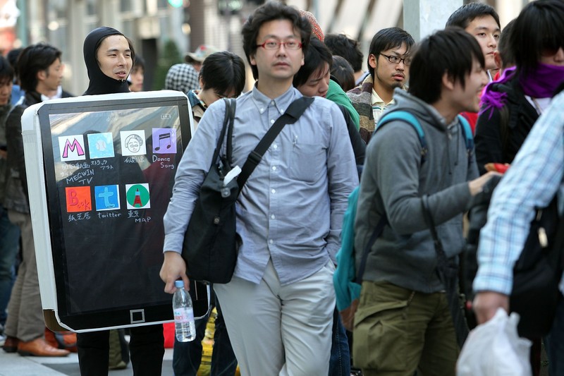 TOKYO - MAY 28:  Ken Sekine (L) in an iPad costume waits in a queue for Apple Inc.'s iPad tablet computers outside the Apple Store Ginza on the day of its Japanese launch on May 28, 2010 in Tokyo, Japan. The iPad, which has already sold over 1 million units in the U.S. since its release, is available in both the Wi-Fi and the Wi-Fi + 3G models in Australia, Canada, France, Germany, Italy, Japan, Spain, Switzerland and the UK with its international launches.  (Photo by Kiyoshi Ota/Getty Images)