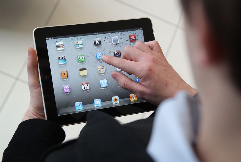 LONDON, ENGLAND - FEBRUARY 17:  In this photo illustration, a man holds an Apple ipad tablet on February 17, 2011 in London, England. Apple sold two million ipads in the first two months of their launch in 2010. Worldwide iPad sales are expected to amount to 20 million in 2012.  (Photo Illustration by Peter Macdiarmid/Getty Images)