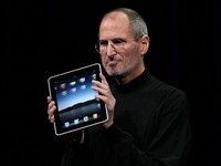 SAN FRANCISCO - JANUARY 27: Apple Inc. CEO Steve Jobs holds up the new iPad as he speaks during an Apple Special Event at Yerba Buena Center for the Arts January 27, 2010 in San Francisco, California. Apple introduced its latest creation, the iPad, a mobile tablet browsing device that is a cross between the iPhone and a MacBook laptop. (Photo by Justin Sullivan/Getty Images)