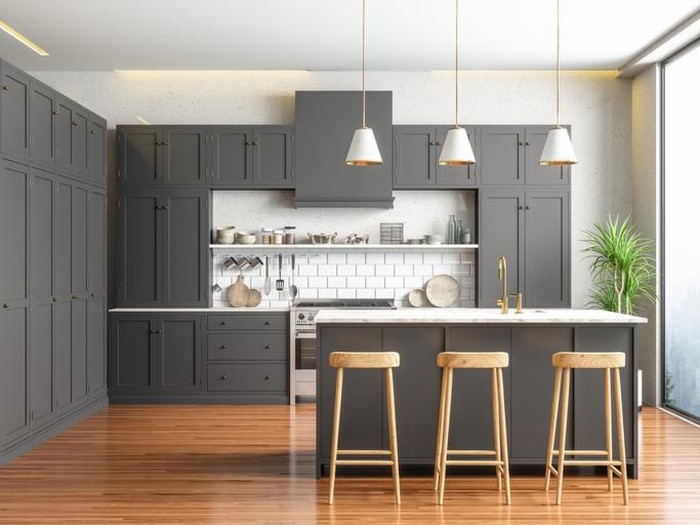 Scandinavian style kitchen with geometric backsplash and blue and white cupboards