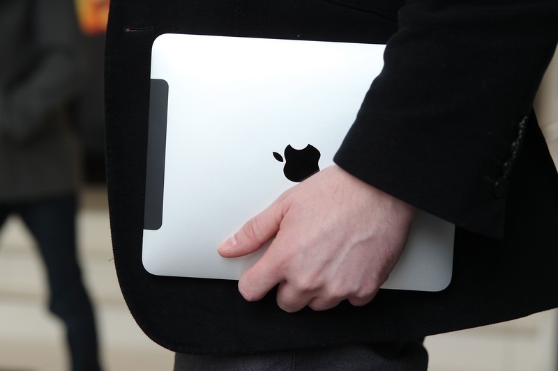 LONDON, ENGLAND - FEBRUARY 17:  In this photo illustration, a man holds an Apple ipad tablet on February 17, 2011 in London, England. Apple sold two million ipads in the first two months of their launch in 2010. Worldwide iPad sales are expected to amount to 20 million in 2012.  (Photo Illustration by Peter Macdiarmid/Getty Images)