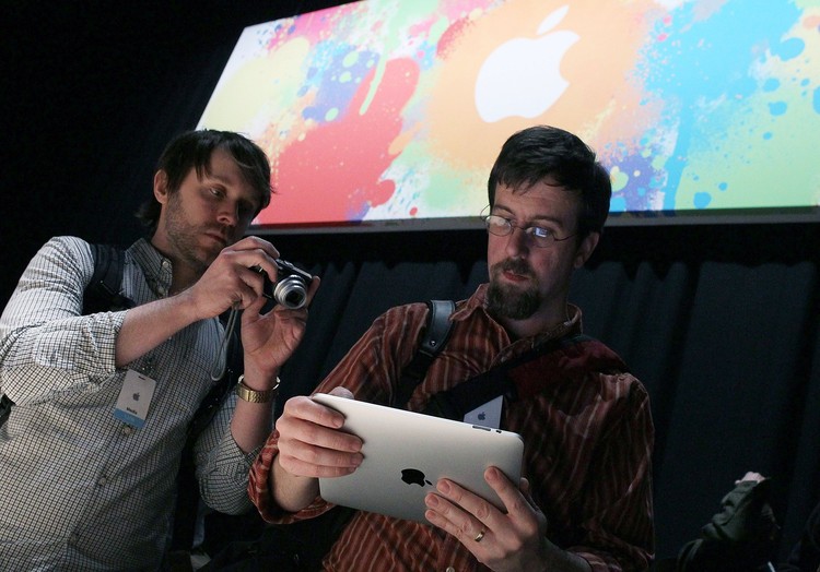 SAN FRANCISCO - JANUARY 27: Apple Inc. CEO Steve Jobs holds up the new iPad as he speaks during an Apple Special Event at Yerba Buena Center for the Arts January 27, 2010 in San Francisco, California. Apple introduced its latest creation, the iPad, a mobile tablet browsing device that is a cross between the iPhone and a MacBook laptop. (Photo by Justin Sullivan/Getty Images)