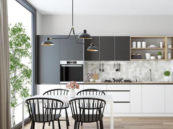 Scandinavian style kitchen with geometric backsplash and blue and white cupboards