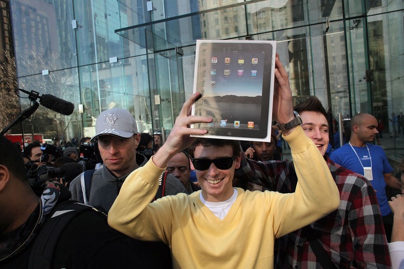 NEW YORK - APRIL 03:  An early customer emerges from the Apple store on Fifth Avenue with Apple Inc's new iPad on April 3, 2010 in New York City.  Hundreds lined up in front of the technology company's flagship New York store to be among the first in the world to acquire the device. The much heralded iPad looks to be a bridge between a laptop and smartphone.  (Photo by Spencer Platt/Getty Images)