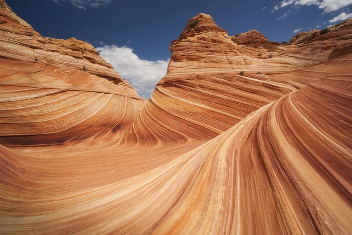 Slot canyon wave pattern with sky reflected in water
