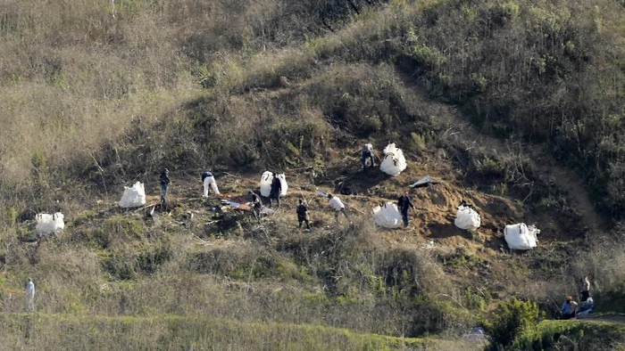 CORRECTS DATE TO JAN. 28, 2020, NOT JULY 23, 2018 - Investigators work Tuesday, Jan. 28, 2020 at the scene of a helicopter crash that killed former NBA basketball player Kobe Bryant, his 13-year-old daughter, Gianna, and seven others, in Calabasas, Calif. (AP Photo/Mark J. Terrill)