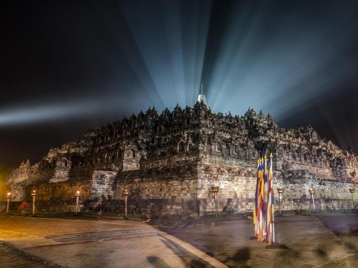MAGELANG, CENTRAL JAVA, INDONESIA - MAY 10: Tourists at Borobudur temple during celebrations for Vesak Day on May 10, 2017 in Magelang, Central Java, Indonesia. Buddhists in Indonesia celebrate Vesak at the Borobudur temple annually, which makes it the most visited tourist attraction in Indonesia. It is observed during the full moon in May or June, with the ceremony centered at three Buddhist temples by walking from Mendut to Pawon and ending at Borobudur. The stages of life of Buddhisms founder, Gautama Buddha, which are celebrated at Vesak are his birth, enlightenment to Nirvana, and his passing (Parinirvana). (Photo by Ulet Ifansasti/Getty Images)