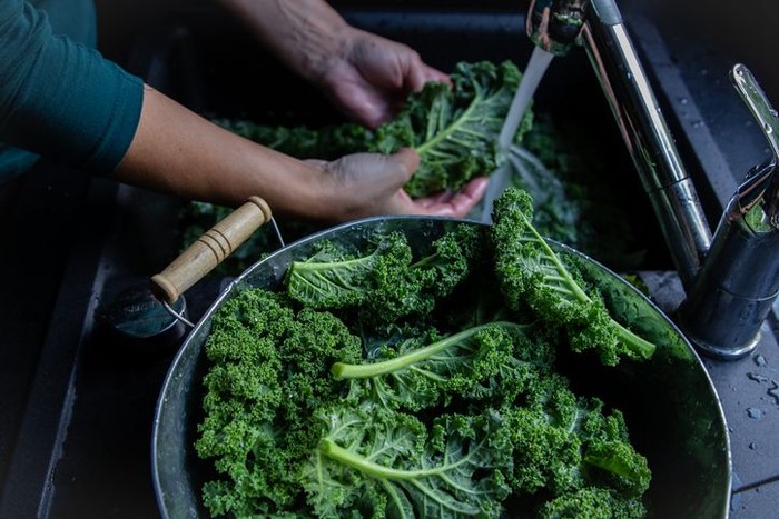 Fresh organic broccoli in an old metal colander shot on rustic wooden table. This vegetable is considered a healthy salad ingredient. Predominant colors are green and brown. Low key DSRL studio photo taken with Canon EOS 5D Mk II and Canon EF 100mm f/2.8L Macro IS USM