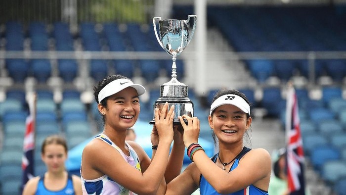 MELBOURNE, AUSTRALIA - JANUARY 31: Alexandra Eala of the Philippines and Priska Madelyn Nugroho of Indonesia pose with the championship trophy after winning their Junior Girls DoublesÂ Final against Ziva Falkner of Slovenia and Matilda Mutavdzic of Great Britain on day twelve of the 2020 Australian Open at Melbourne Park on January 31, 2020 in Melbourne, Australia. (Photo by Morgan Hancock/Getty Images)